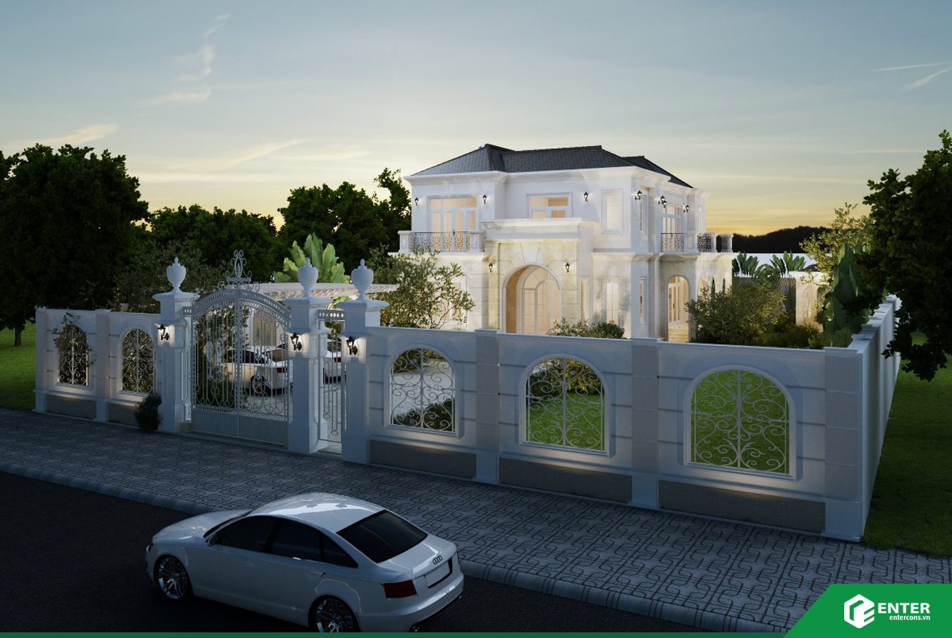 Biệt thự trắng hai tầng có cổng rào, sân vườn và xe đậu trước nhà hoàng hôn.